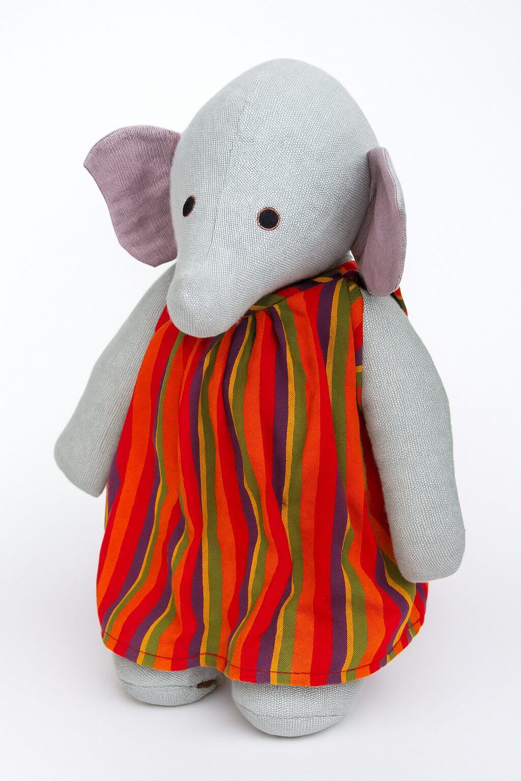 Barefoot large elephant in red striped dress 1